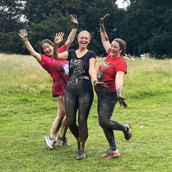 Slimming World members covered in mud jumping after Race for Life