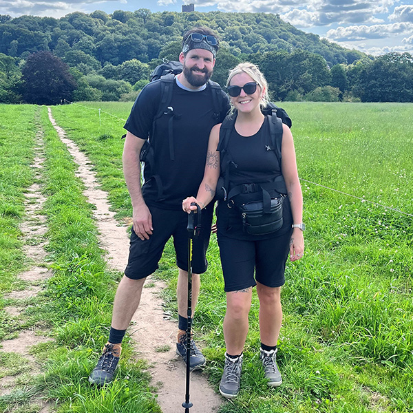 member with friend walking