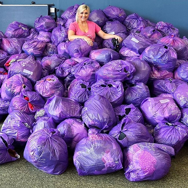 Slimming World member surrounded by filled clothes throw bags