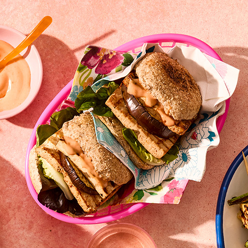 Tofu and aubergine slices layered in a toasted wholemeal roll with burger sauce and lettuce