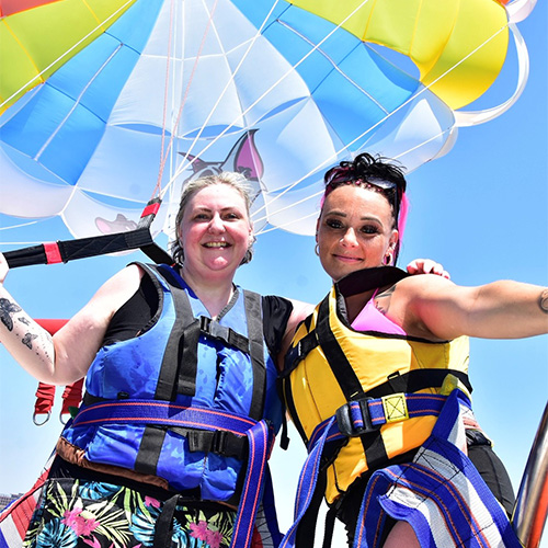 Slimming World member Bex posing with her niece with a colourful parachute behind them