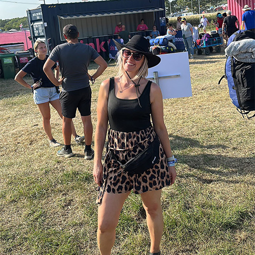 Slimming World member Sarah standing in front of a stage at a music festival